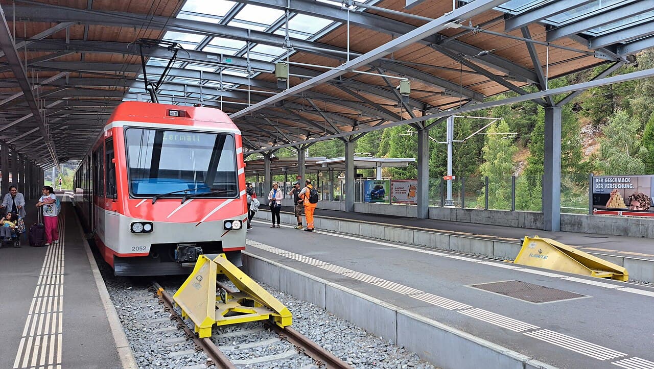 A Matterhorn Gotthard Railway train at Tasch station, destination board reading Zermatt